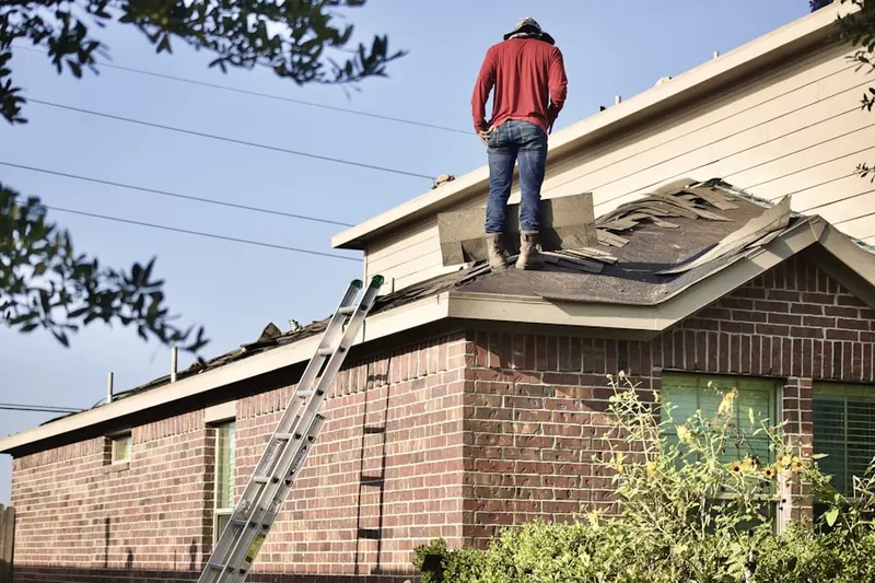 Professional roofer working on a residential roof in Countryside West